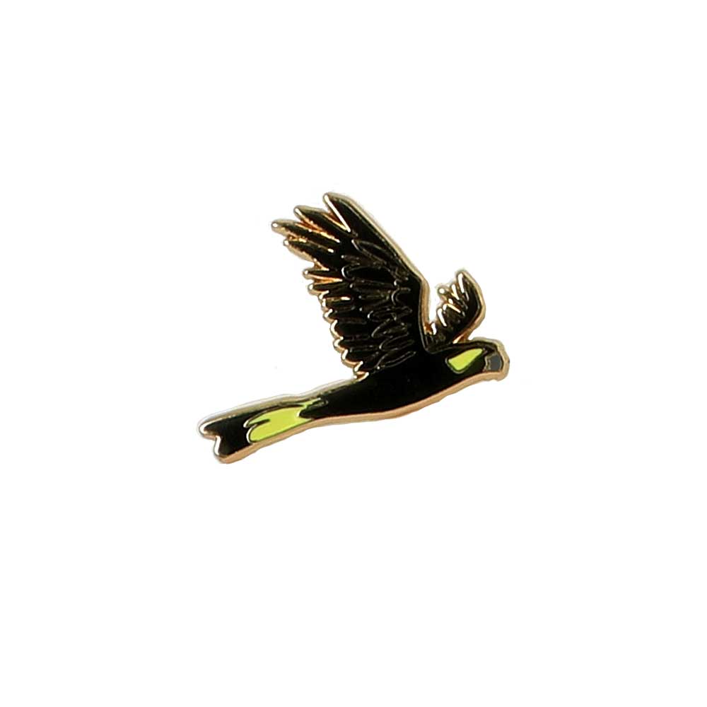 Yellow tailed cockatoo in flight enamel pin on white background