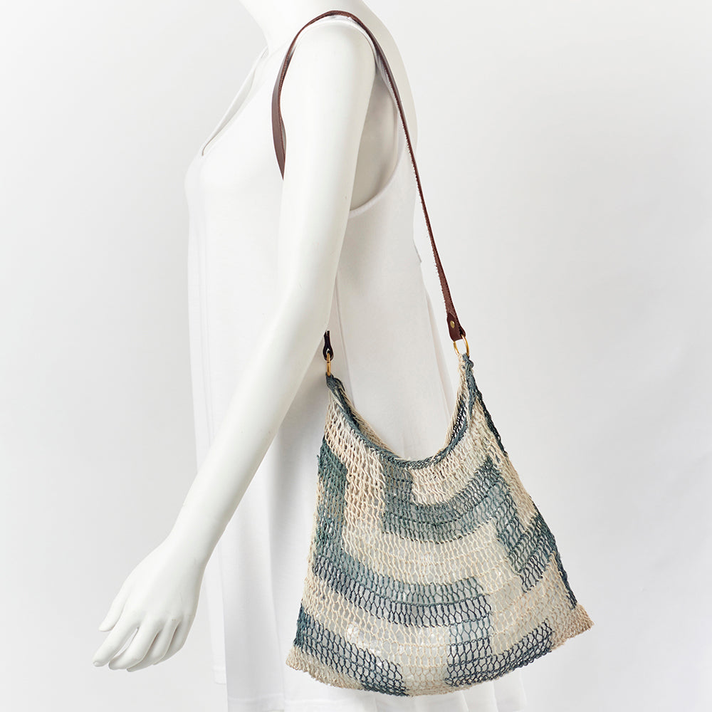 Authentic handwoven bilum  bag, with leather strap, from the Morobe Province of Papua New Guinea.