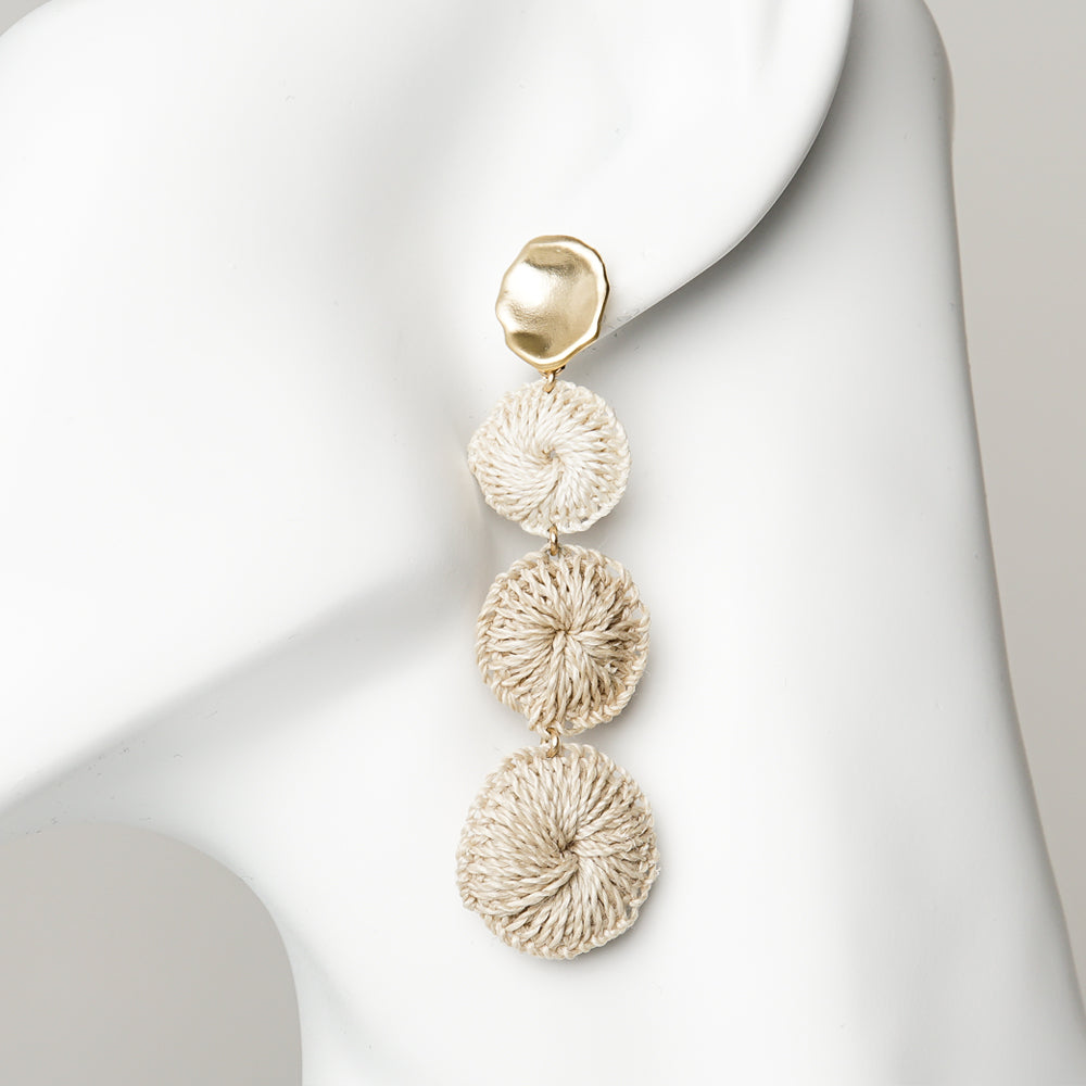 Gold plated raw brass discs with a drop of three handwoven bilum fibre discs. Ear posts made of sterling silver.