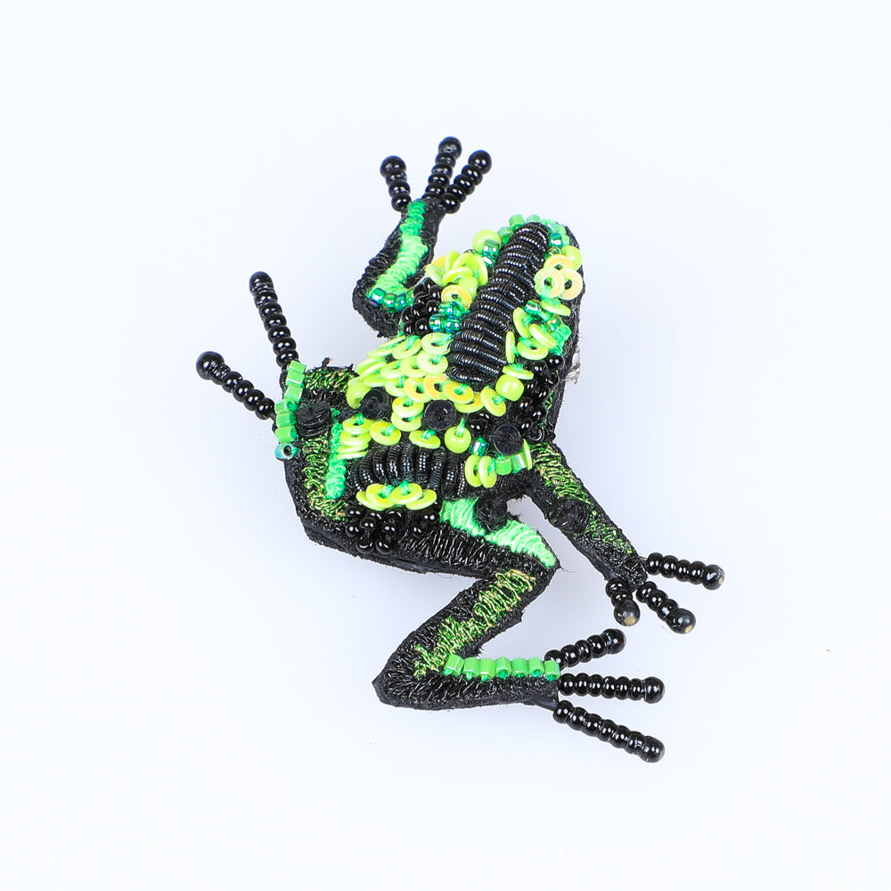 Beaded nature brooch hand made in india on white background. Green Flying Frog brooch