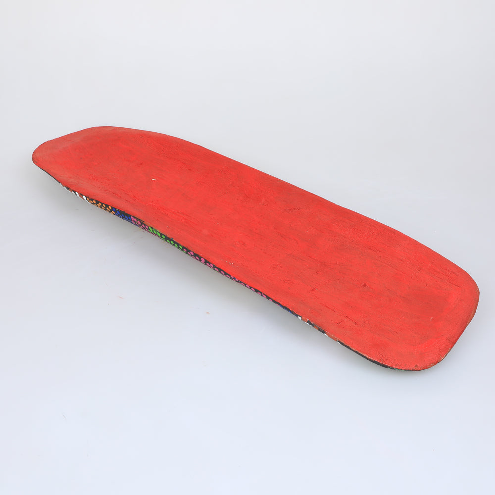 Hand carved and hand painted coolamon on white background